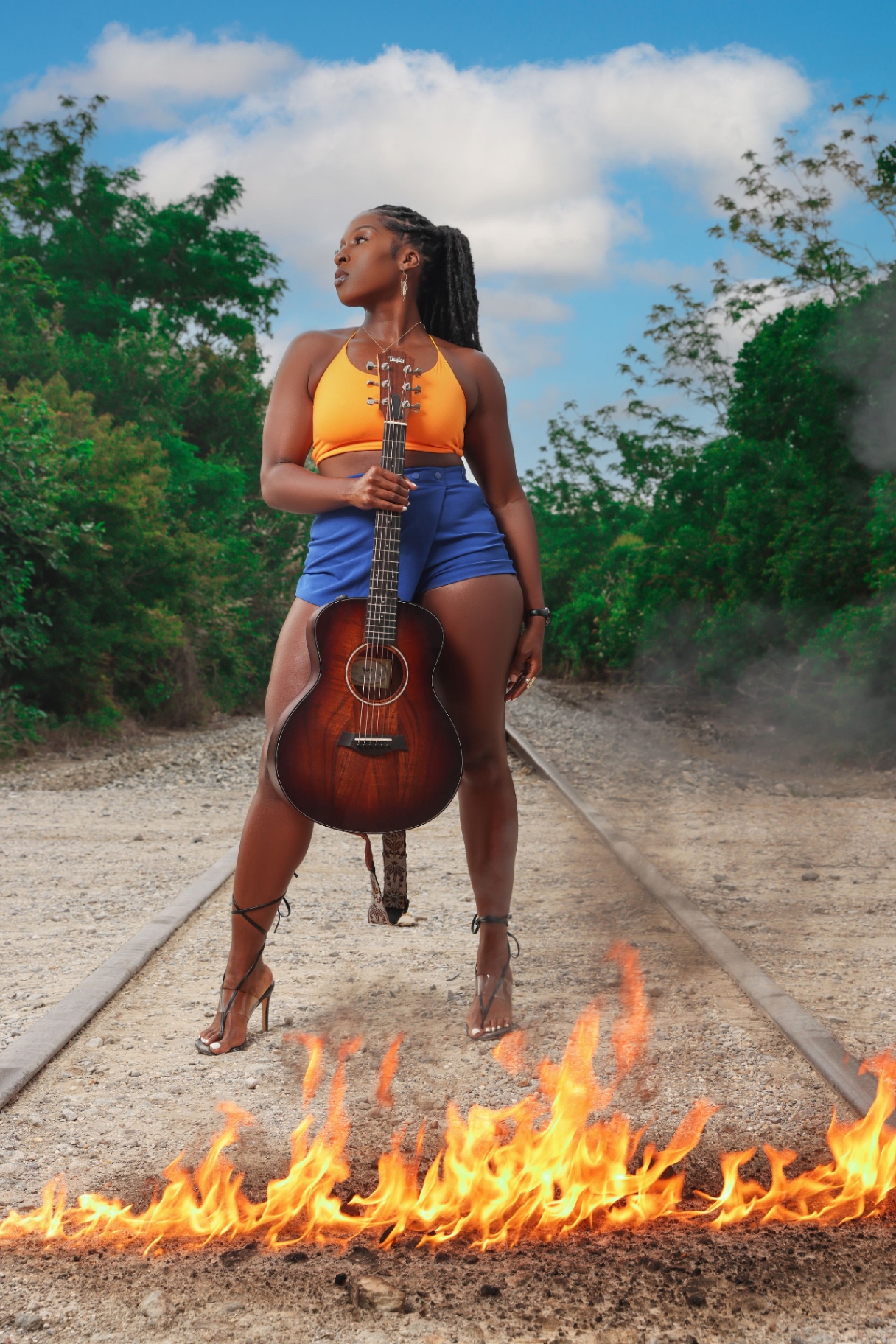The Real Bobbi Rae — guitar in hand, on the tracks.
