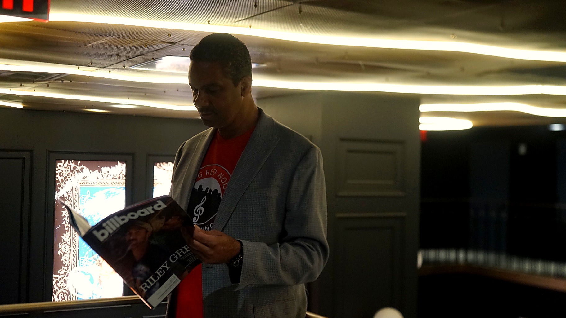 Cyril Darensbourg reading an issue of Billboard magazine