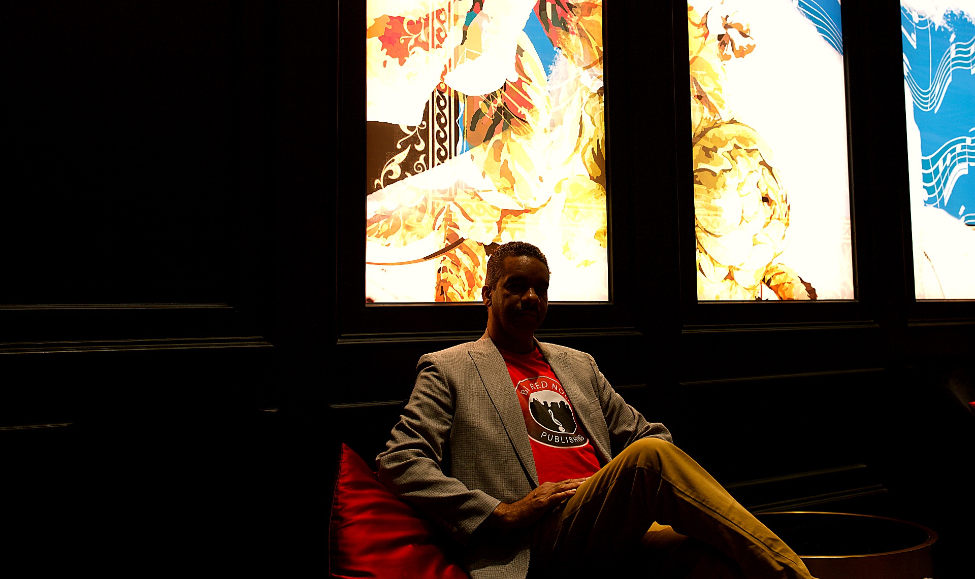 Cyril Darensbourg framed against illuminated wall panels during a portrait session