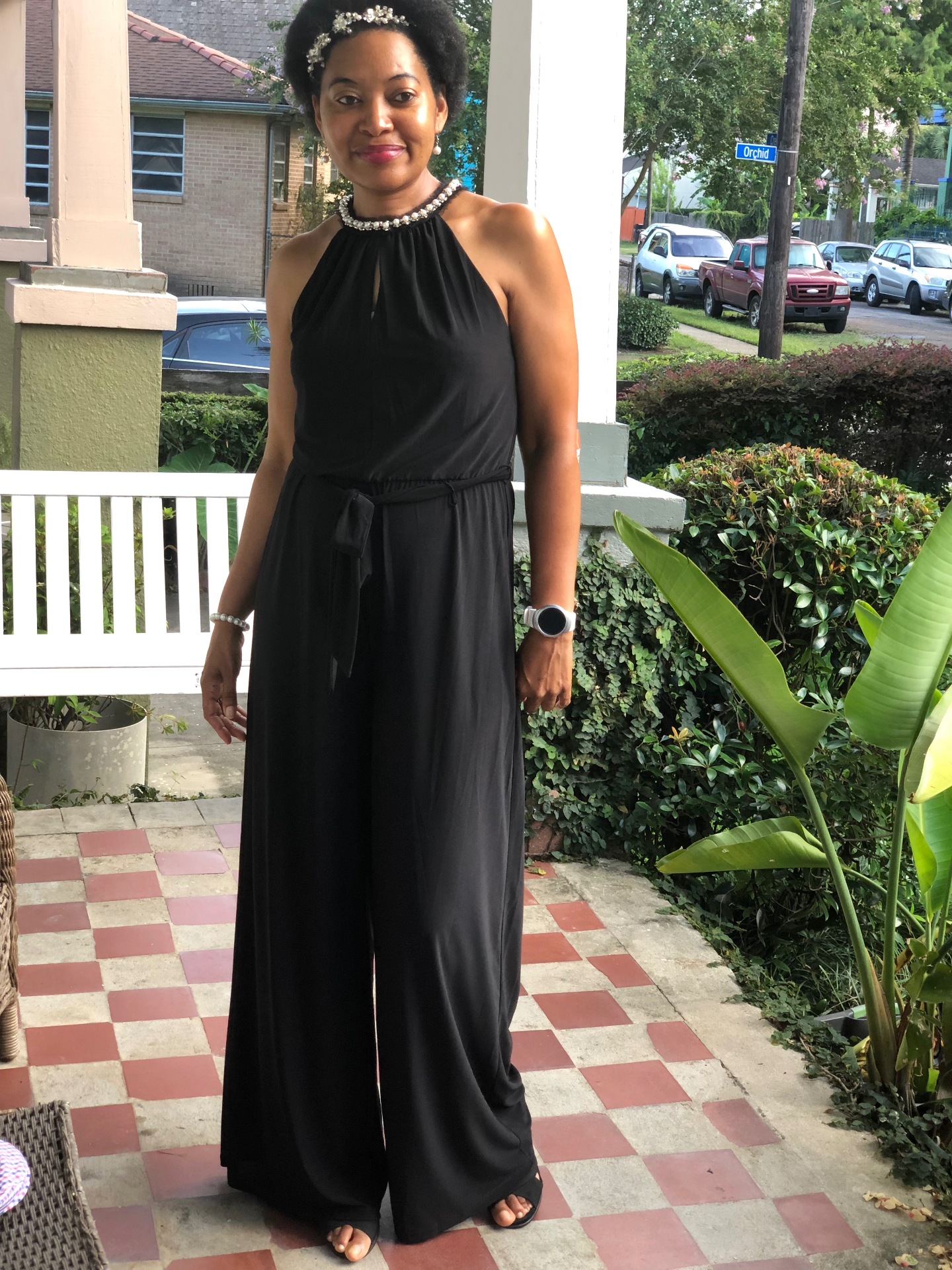 Dr. Stephanie Jupiter in a black jumpsuit on her New Orleans porch